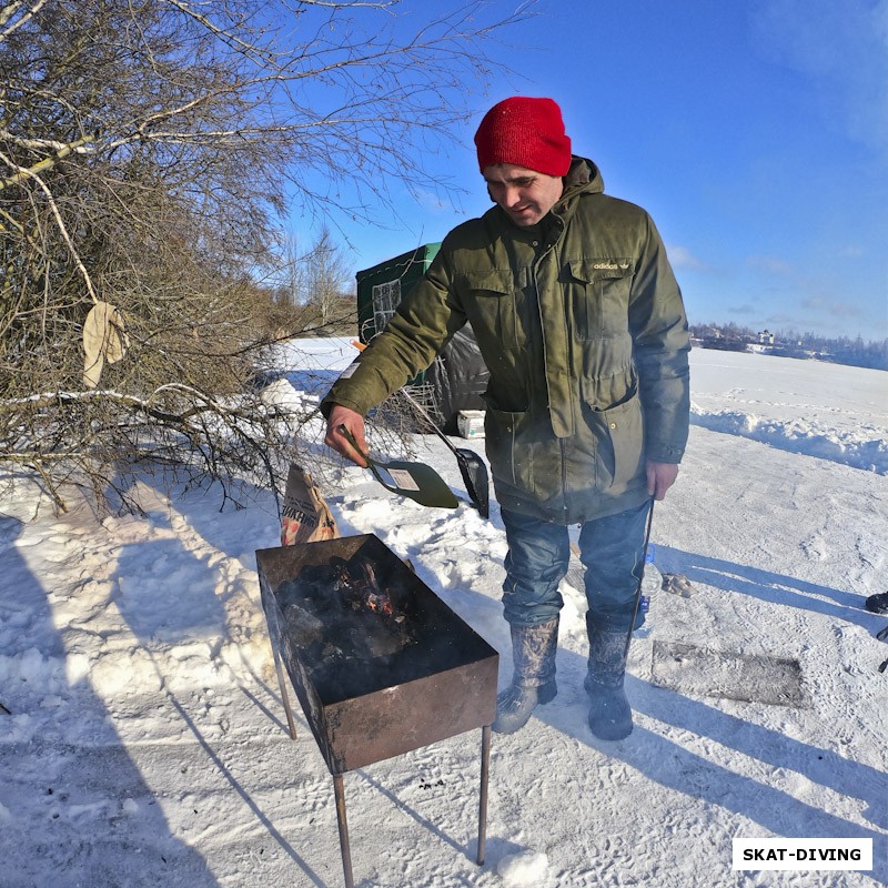 Корнеев Алексей, готовит мангал для шашлыка